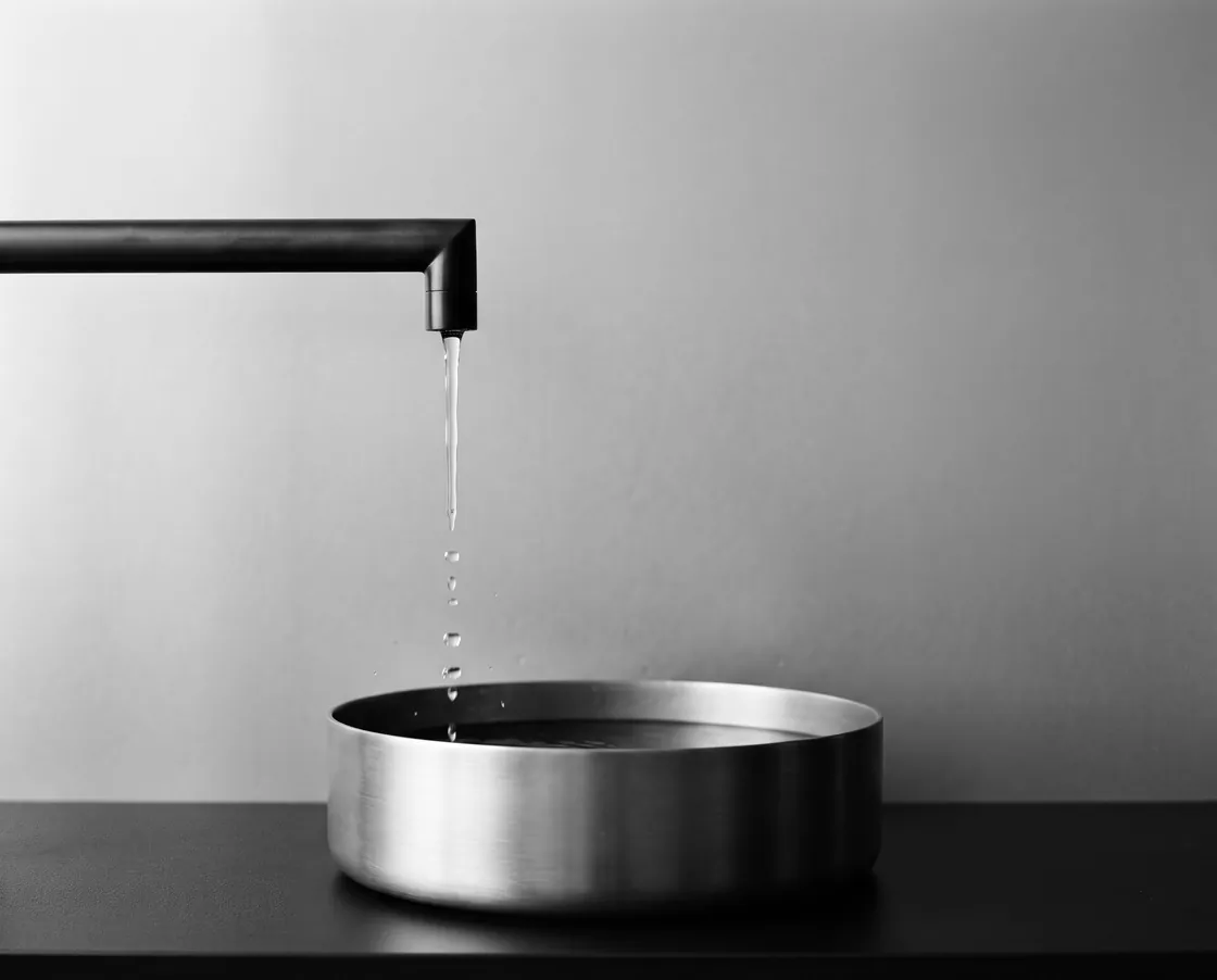 Cold water falling into a brushed steel basin