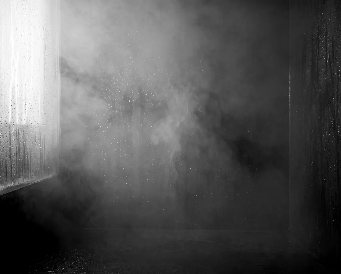 White steam rising through a shaft of window light