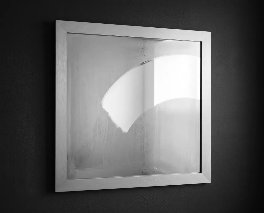 A fogged mirror with one clean wiped arc